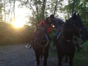 Couple kissing while on a trail ride