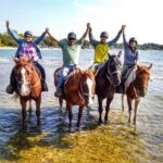 Group of friends horseback riding